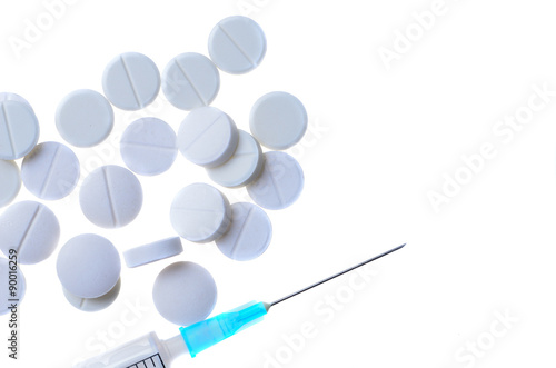 pills with a syringe isolated on a white background