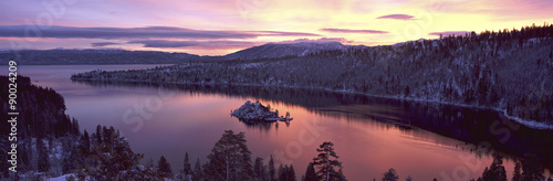 This is Emerald Bay at sunrise after a winter snow storm. There is snow on the land surrounding the bay.