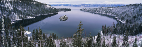 This is Emerald Bay after a winter snow storm. There is snow covering the ground surrounding the bay. #90024250