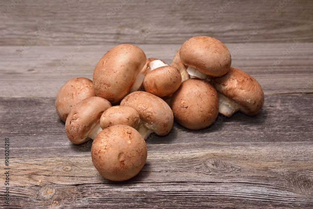 Champignon mushroom on a wooden background Champignon mushroom on a wooden background