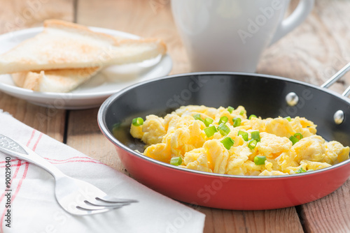 Scrambled egg with bread and coffee.
