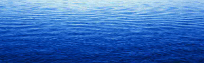 These are water reflections in Lake Tahoe. The water is a deep blue and the small ripples in the water form a pattern.