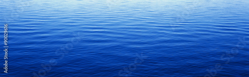These are water reflections in Lake Tahoe. The water is a deep blue and the small ripples in the water form a pattern.