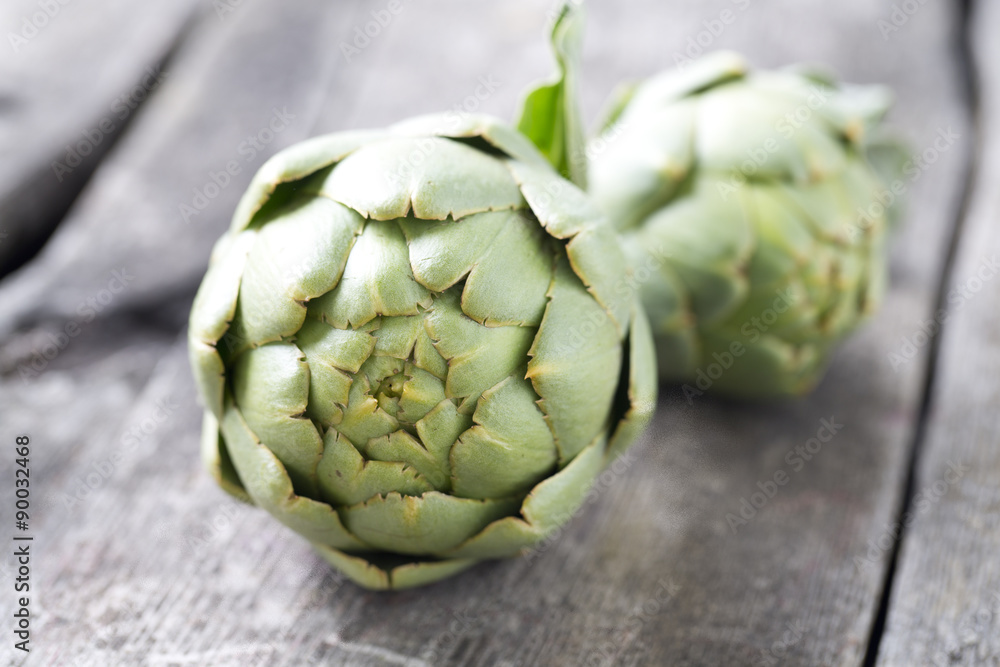 Fototapeta premium artichokes on wooden surface