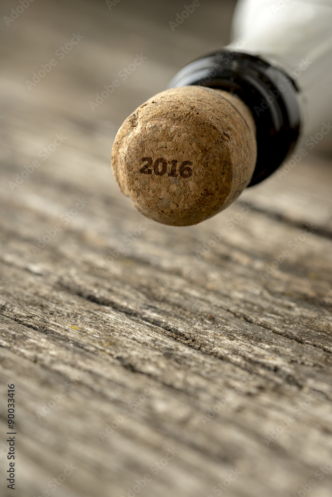 Top of the champagne bottle with 2016 sign on the cork