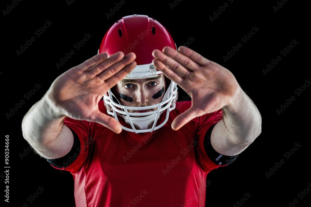 Portrait of american football player protecting himself 
