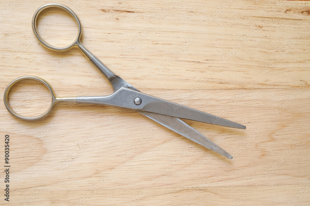 Scissors on wood background Scissors on wood background