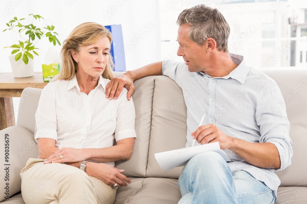 Concerned therapist comforting female patient Concerned therapist comforting female patient