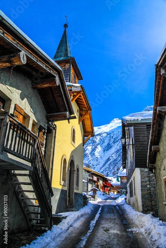 Street in a village in snowy mountain area. photo