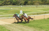 Two girls jockey riding race horse