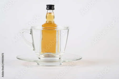 whiskey in cup on white table