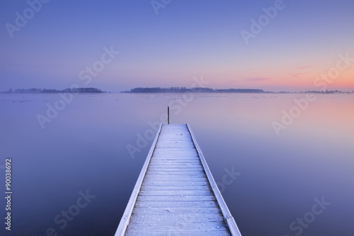 Fototapeta Naklejka Na Ścianę i Meble -  Jetty on a still lake in winter in The Netherlands
