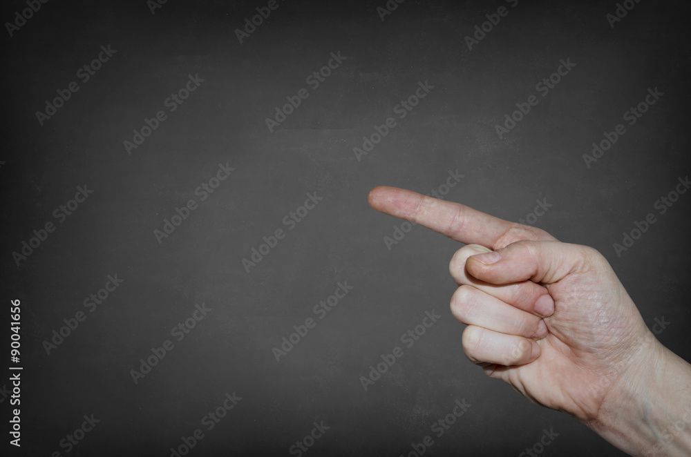 Finger point at the blank blackboard Finger point at the blank blackboard
