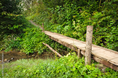 Landscape with a wooden bridge over a river 