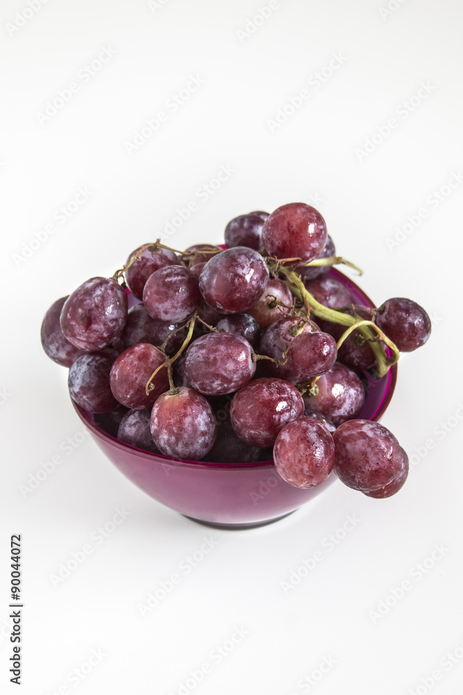 Fresh red grapes in a purple bowl Fresh red grapes in a purple bowl