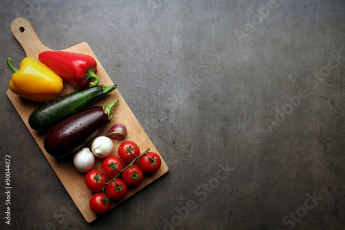 Ratatouille vegetables on wooden cutting board with space for recipe text