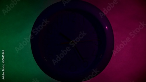 Clock on color wooden plank wall, night Light