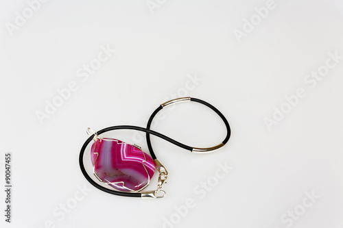 Handmade pendant with decorated stone on isolated white backgrou