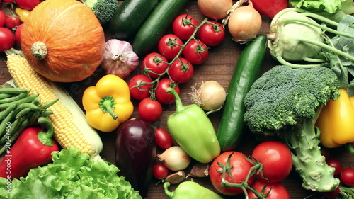 Vegetables filling entire wooden kitchen table - harvest concept - stop motion animation