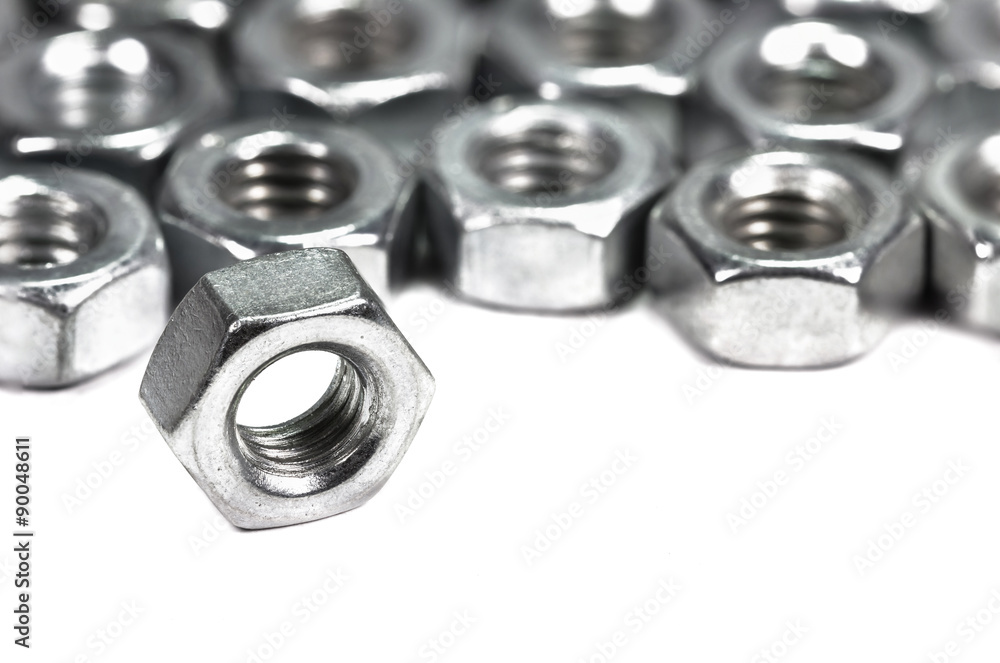 Closeup metal screw (bolt) and nuts on white background. Closeup metal screw (bolt) and nuts on white background.