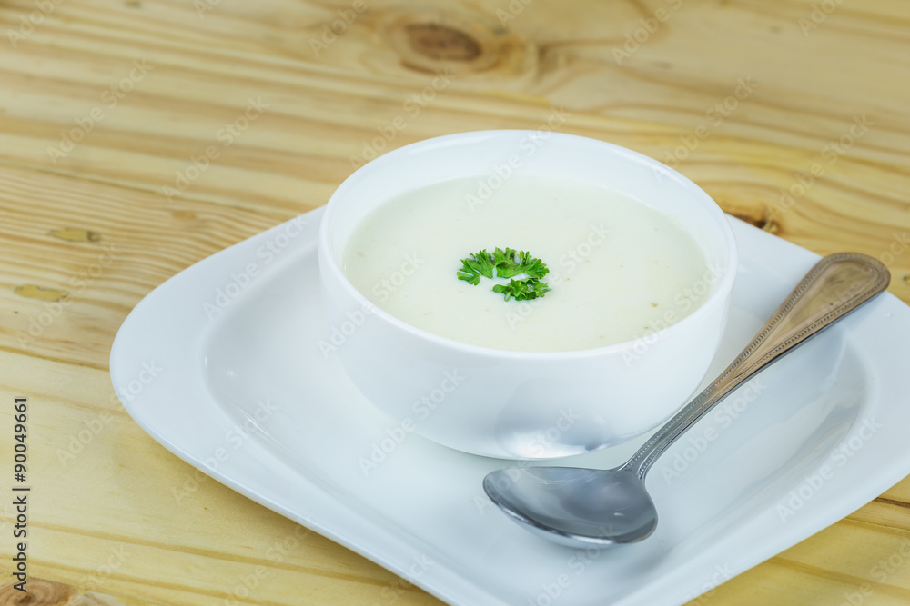 Cream soup in white bowl on wooden table Cream soup in white bowl on wooden table
