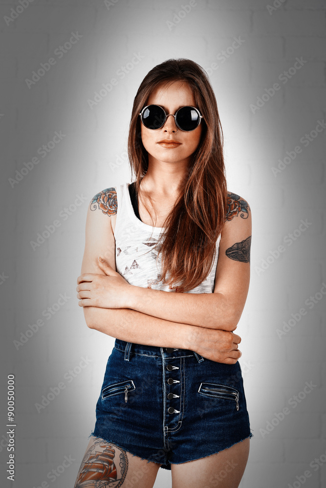 Beautiful girl with stylish make-up and tattooed body on light background Beautiful girl with stylish make-up and tattooed body on light background