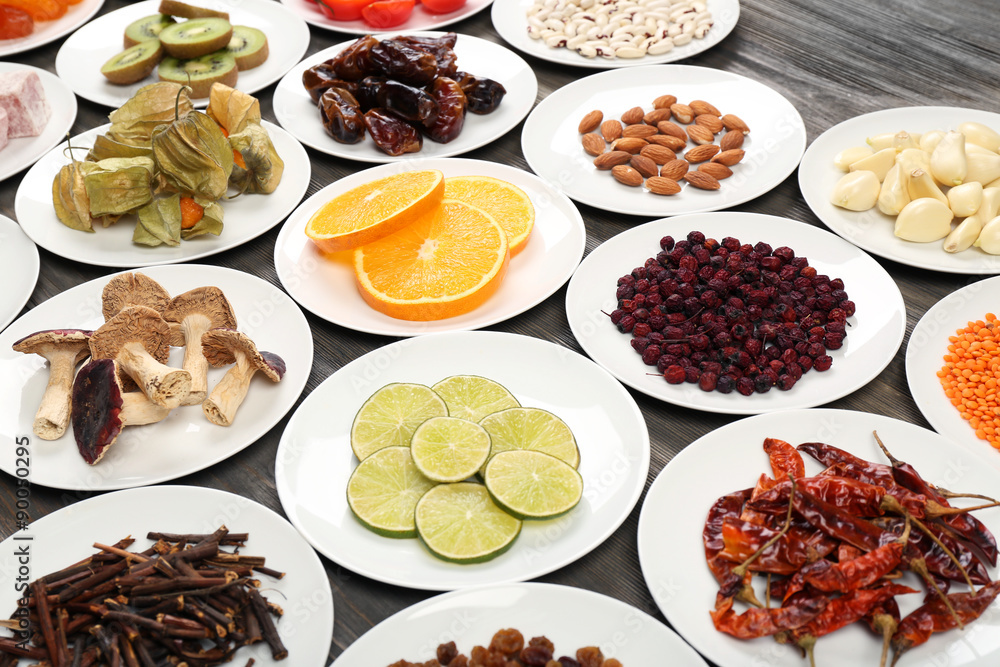 Different products on saucers on wooden table, closeup Different products on saucers on wooden table, closeup