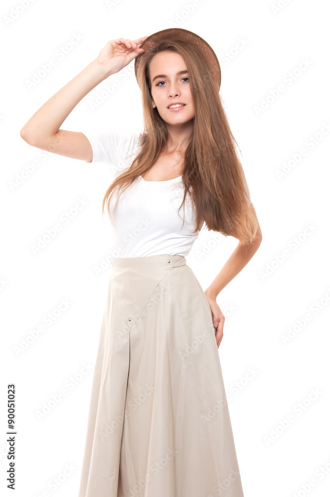 Young woman in long skirt and straw hat isolated on white