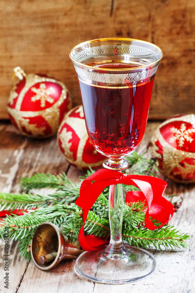 Red sparkling wine in the glass, tree branches, Christmas tree b Red sparkling wine in the glass, tree branches, Christmas tree b