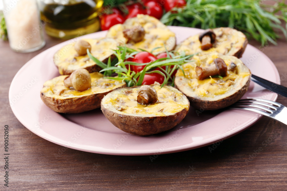 Baked potatoes with cheese and mushrooms on table close up