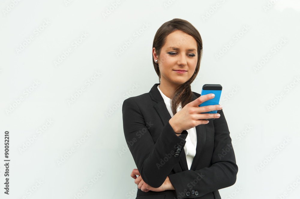Business woman talking by phone against the glass wall in the ci Business woman talking by phone against the glass wall in the ci