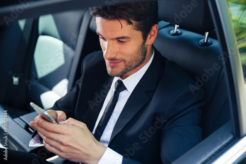 Businessman using smartphone in car © Drobot Dean