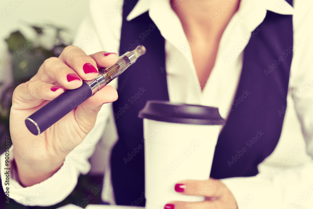 young woman vaping from an electronic cigarette