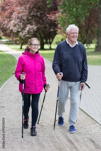 Elderly couple doing nordic walking