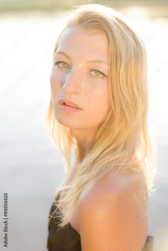 Amazing calm beautiful blond young female on water background Amazing calm beautiful blond young female on water background