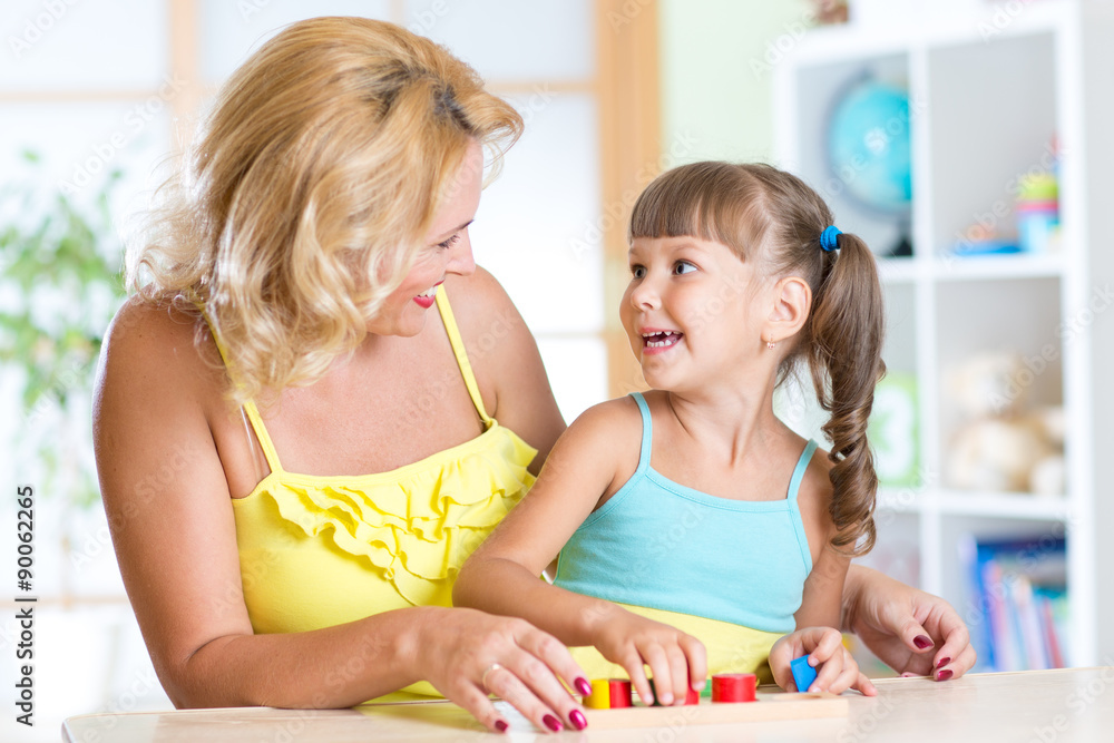 mother and child play together with educational toys mother and child play together with educational toys