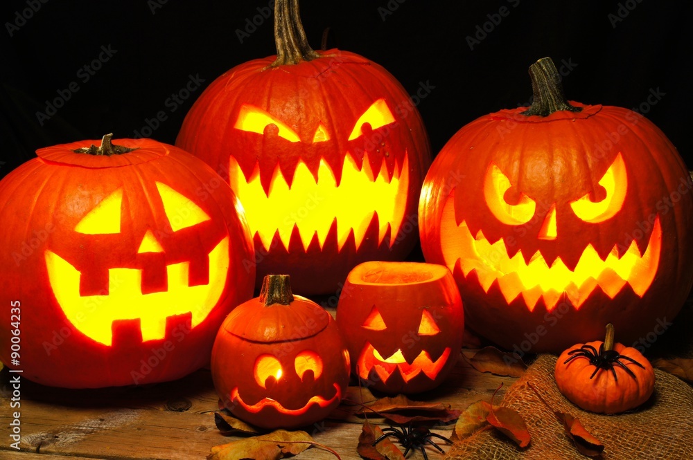 Halloween night scene with a group of spooky illuminated Jack o Lanterns Halloween night scene with a group of spooky illuminated Jack o Lanterns