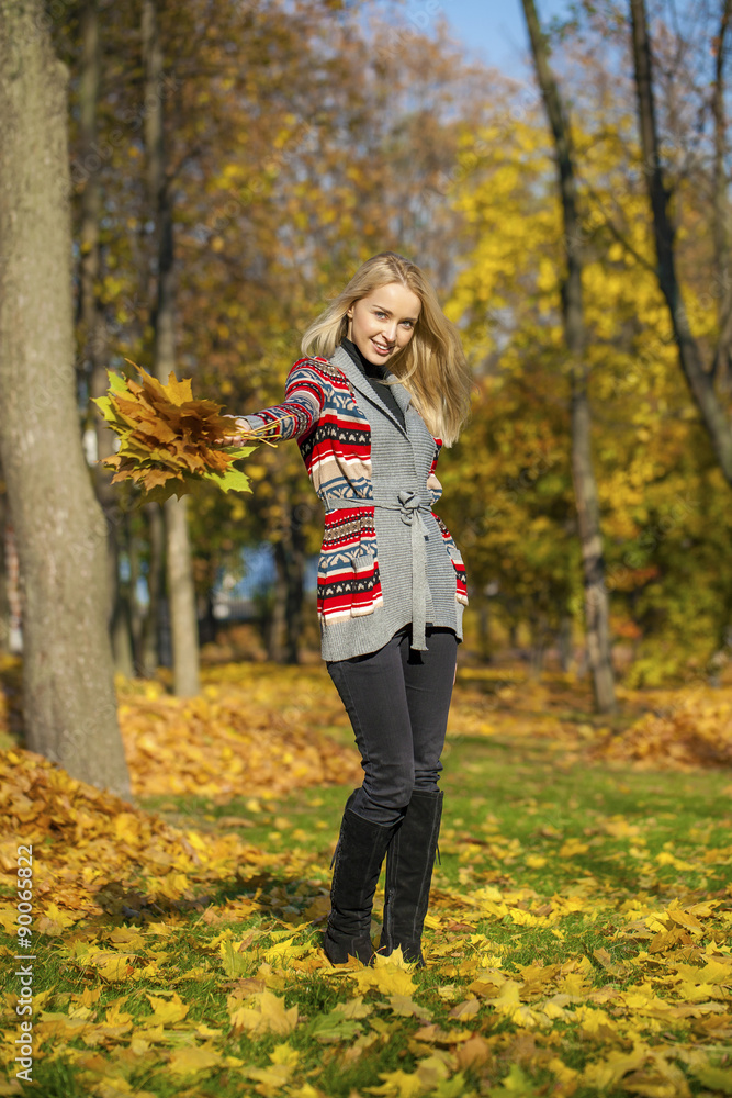 Happy Beautiful blonde woman walks in autumn park Happy Beautiful blonde woman walks in autumn park
