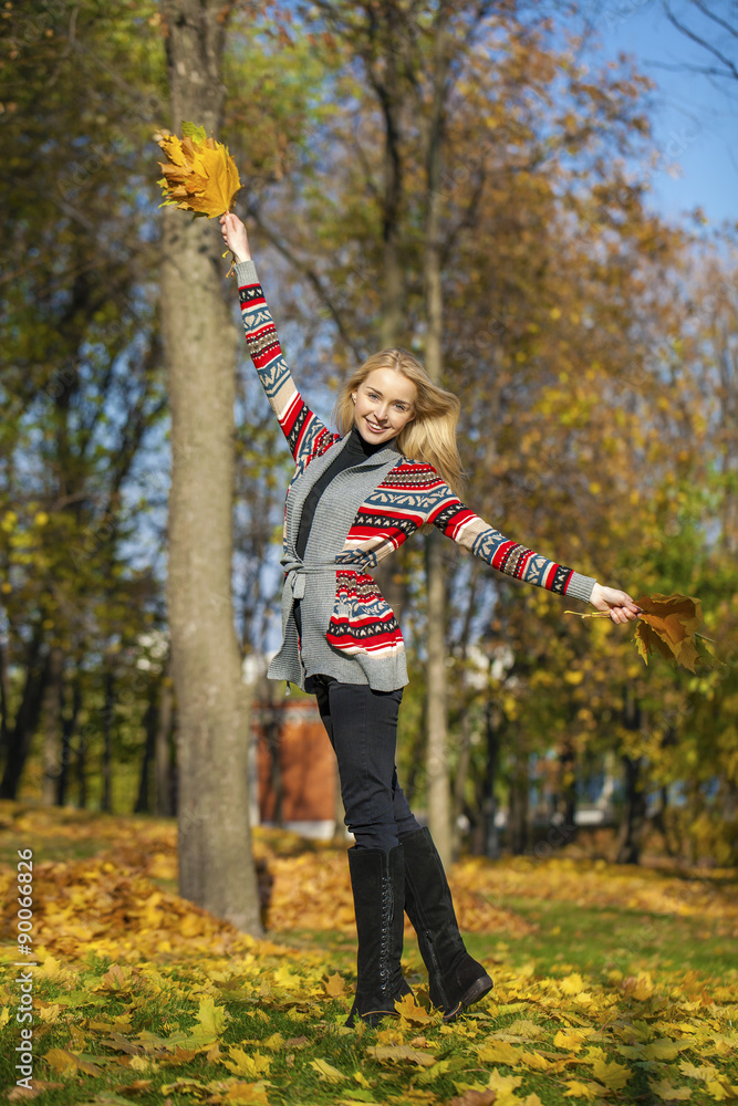 Happy Beautiful blonde woman walks in autumn park Happy Beautiful blonde woman walks in autumn park