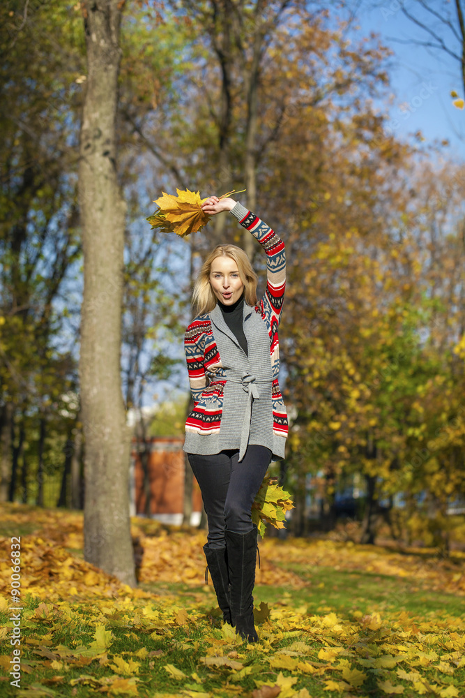 Happy Beautiful blonde woman walks in autumn park Happy Beautiful blonde woman walks in autumn park