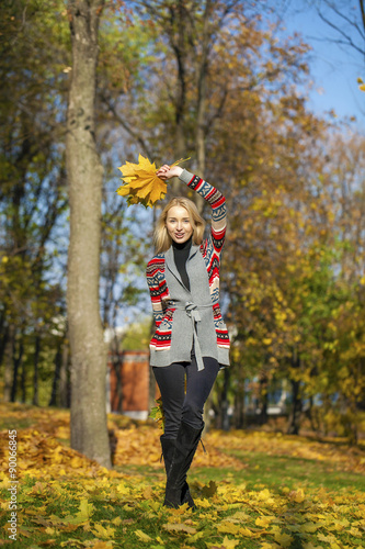 Happy Beautiful blonde woman walks in autumn park © Andrey_Arkusha