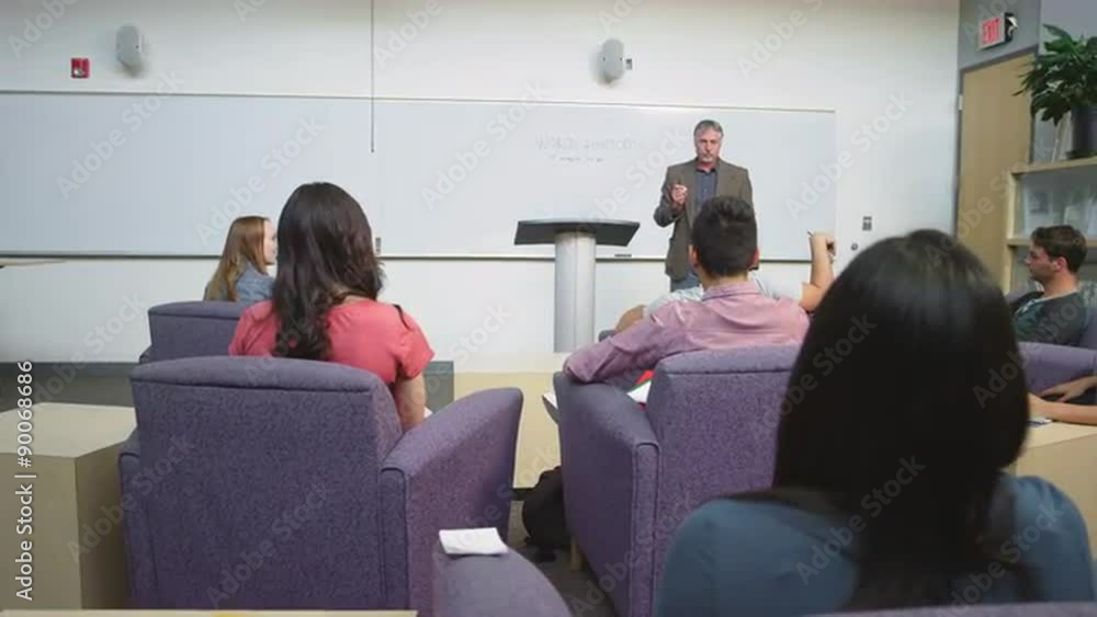 A student raises her hand and the professor calls on other people
A student raises her hand and the professor calls on other people