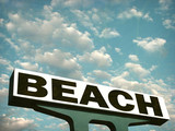 aged and worn vintage photo of beach sign