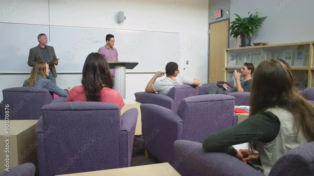 A student giving a presentation to the class and writing on the whiteboard
A student giving a presentation to the class and writing on the whiteboard