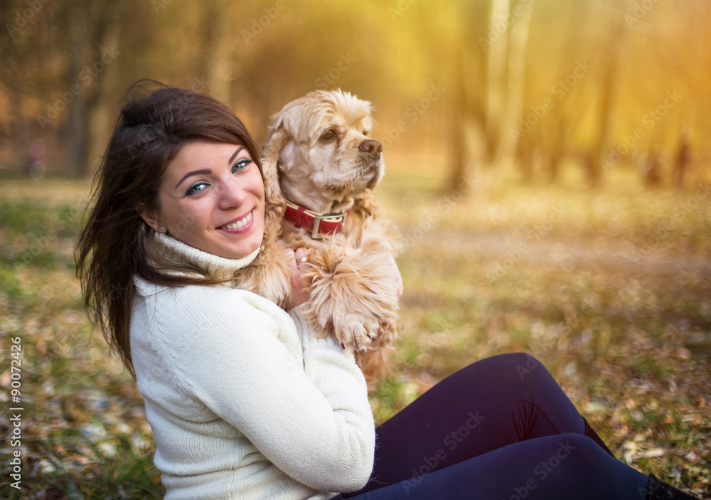 Pretty woman with beautiful cocker spaniel in autumn park Pretty woman with beautiful cocker spaniel in autumn park