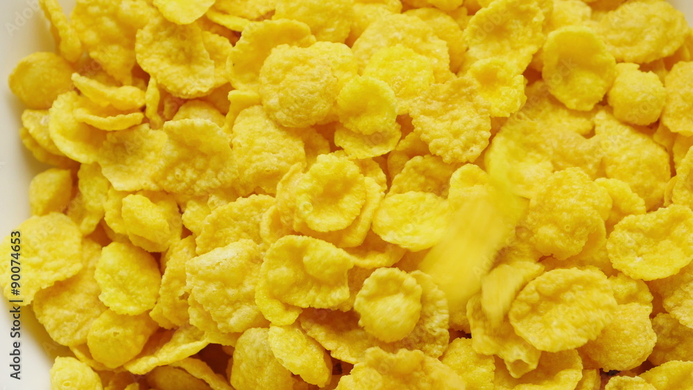 Corn flakes being poured into bowl. Close up.
Corn flakes being poured into bowl. Close up.