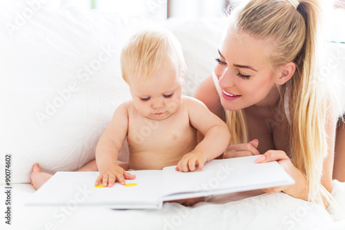 Mother reading book with baby