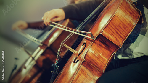 Slika na platnu Symphony orchestra on stage, hands playing cello