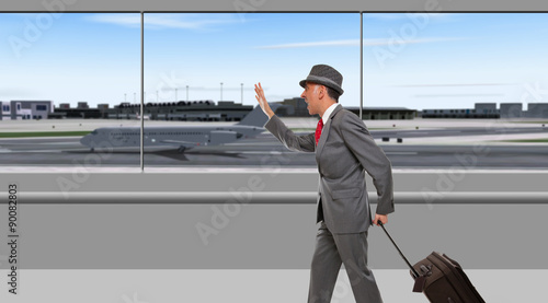 Fotografija Businessman running through airport terminal