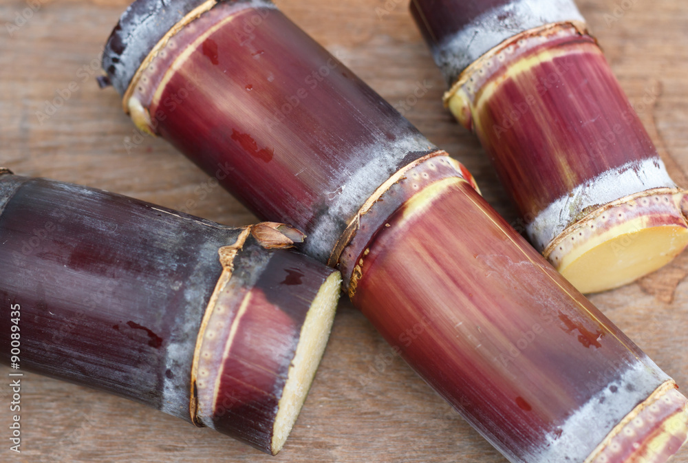 Close up Sugar cane on wood background.